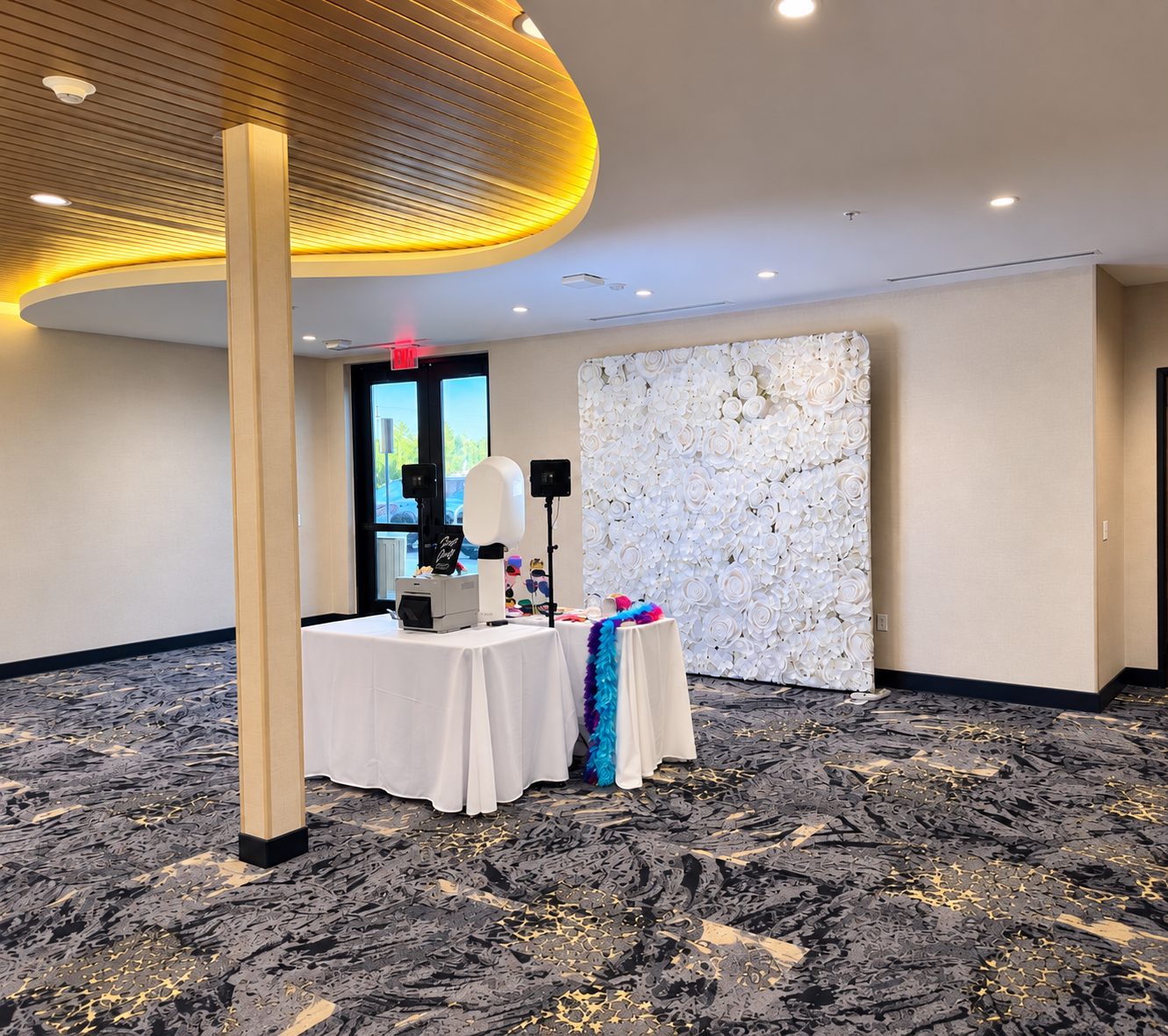 The Olive Booth Co. photo booth setup at an indoor event