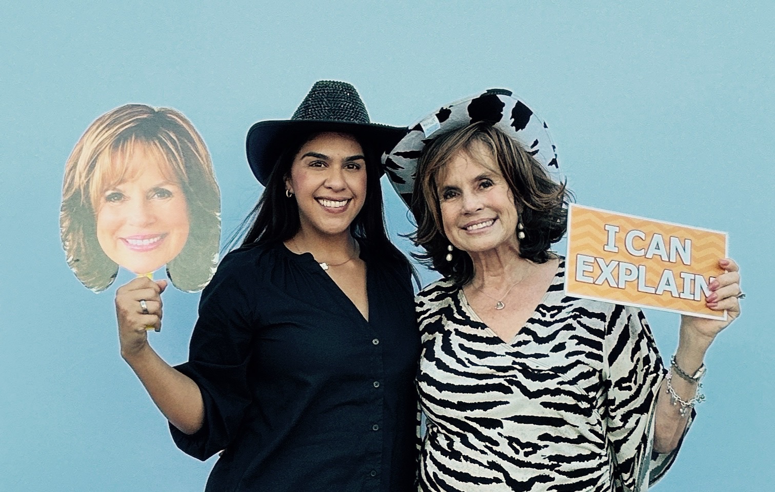 Guests holding customized photo booth props at a Toyota of Orange event