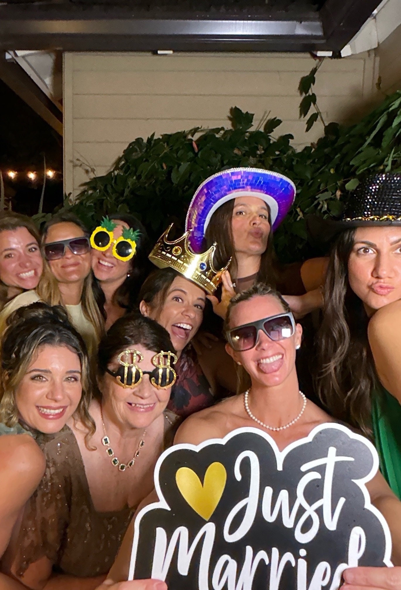 Wedding party enjoying the photo booth with playful props