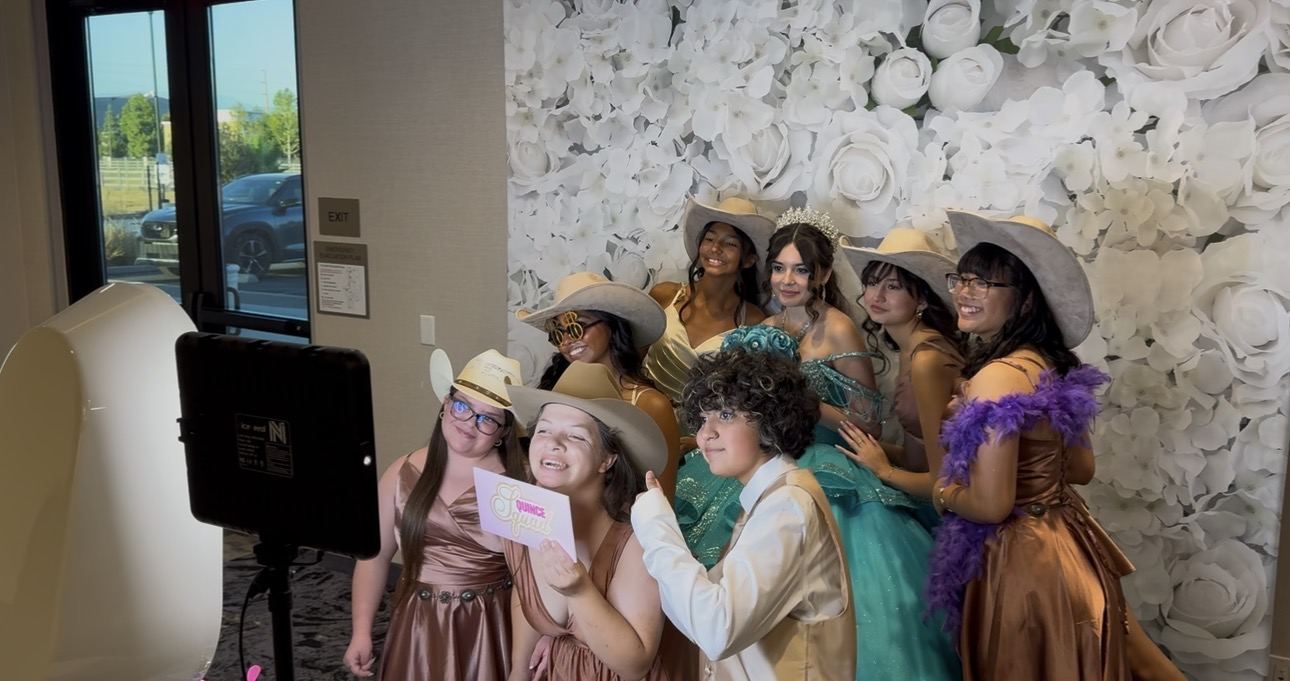 Quinceañera guests using the photo booth